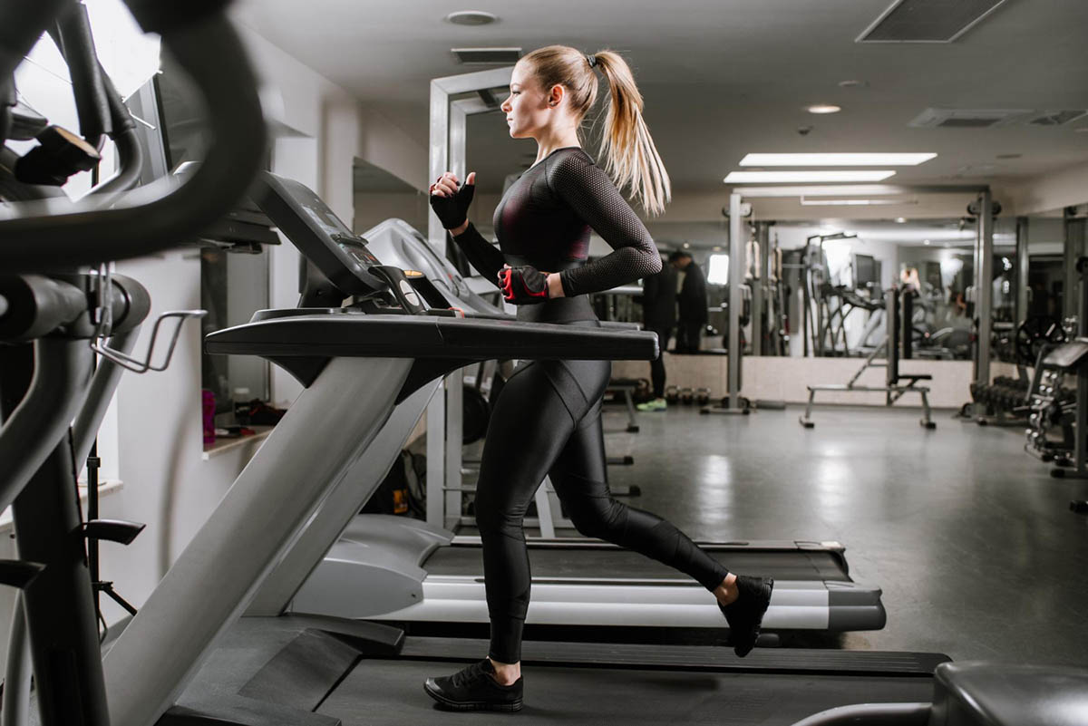 fit-woman-running-treadmill-gym
